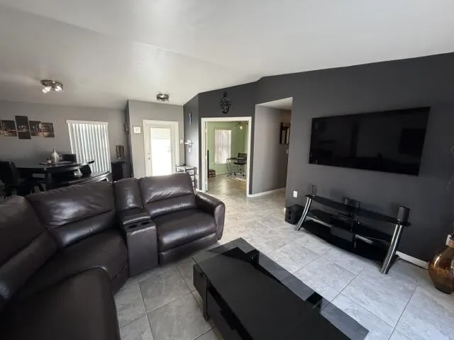 Recessed lighting, tile flooring, and a dining area with vertical blinds