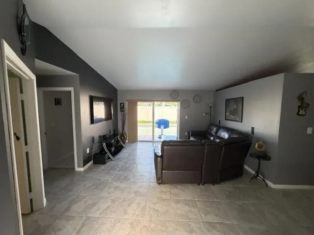 Tile flooring, sliding glass door, recessed lighting, and an open layout