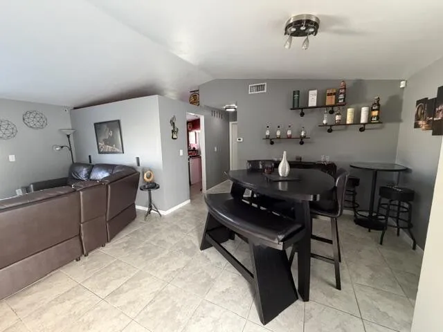 Tiled flooring throughout, recessed lighting, and wall-mounted shelving