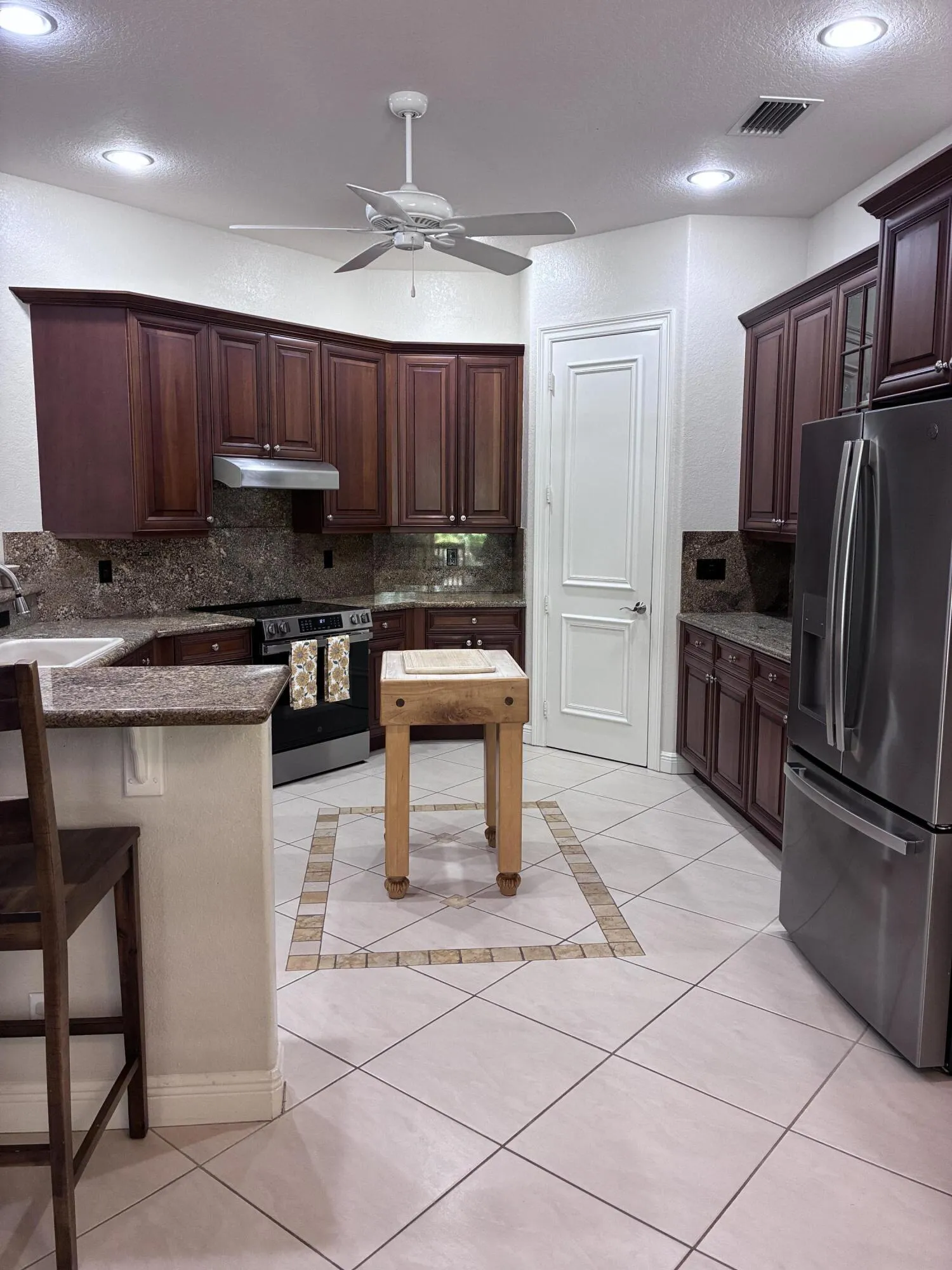 Large kitchen with wood cabinets and granite tops