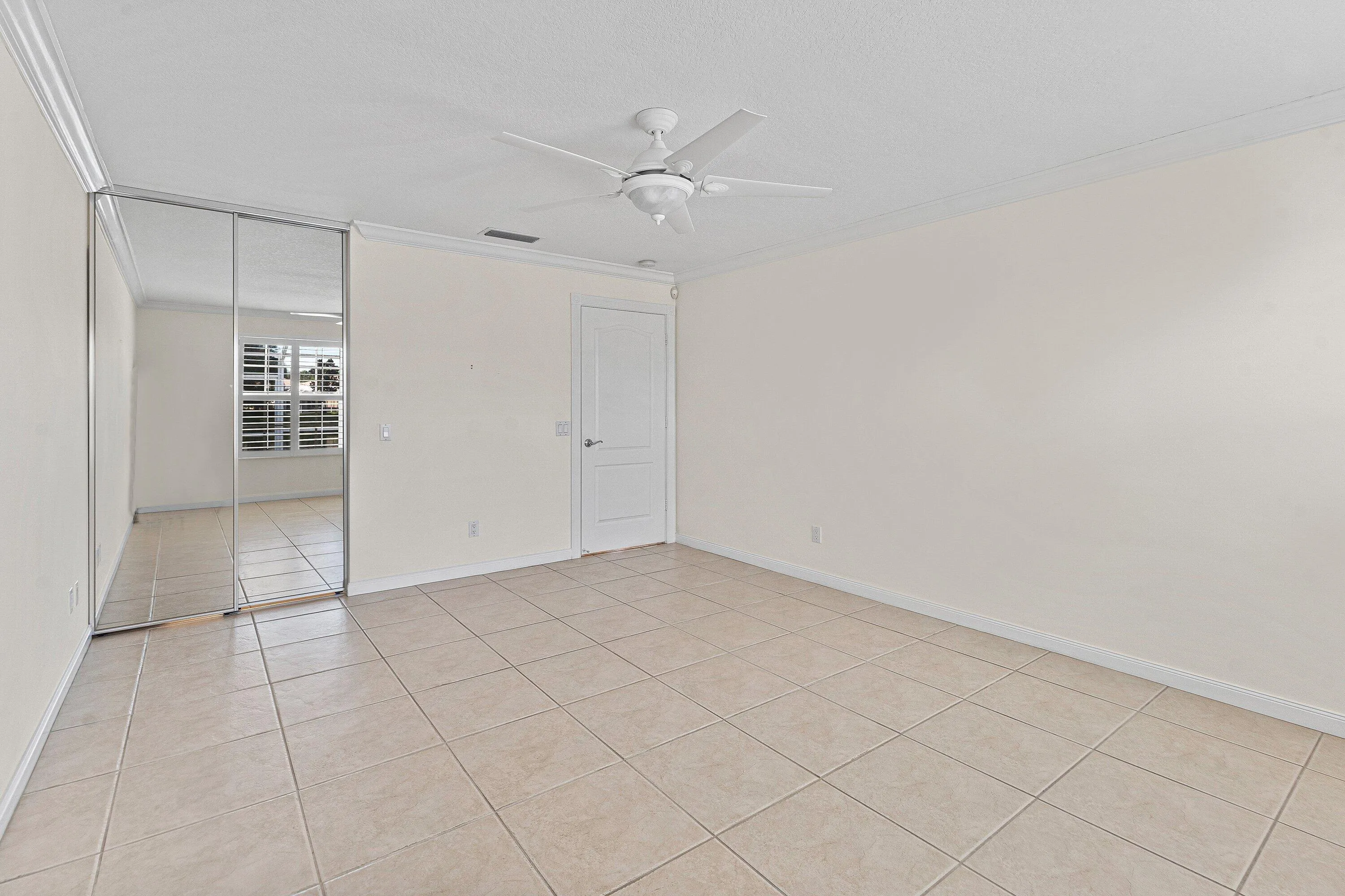 Light-toned tile flooring with white walls