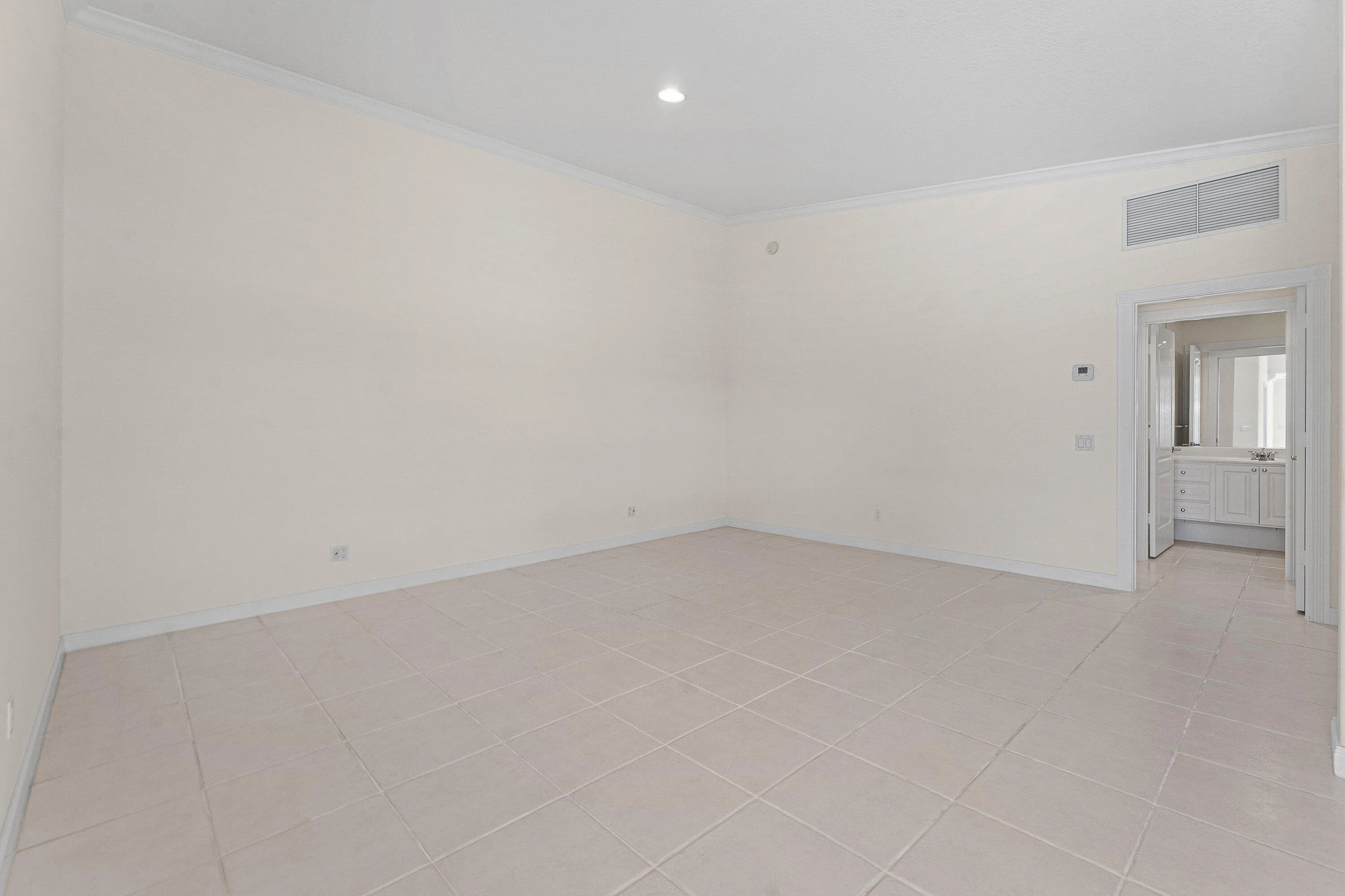 Tile flooring and white walls with crown molding