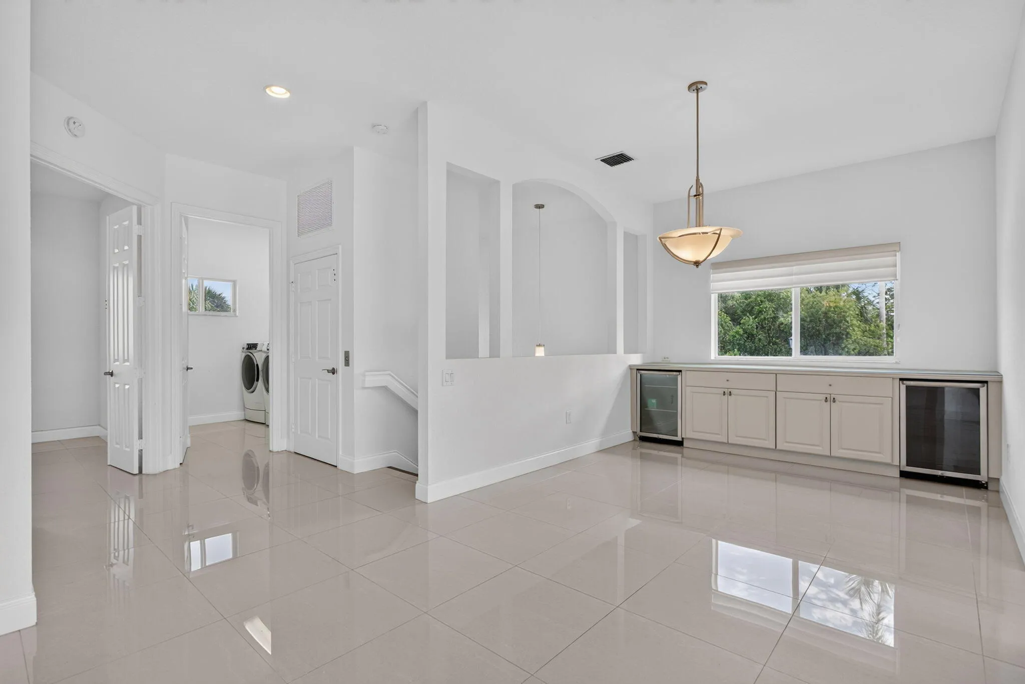 Dining room with built-in wine and beverage refrigerators