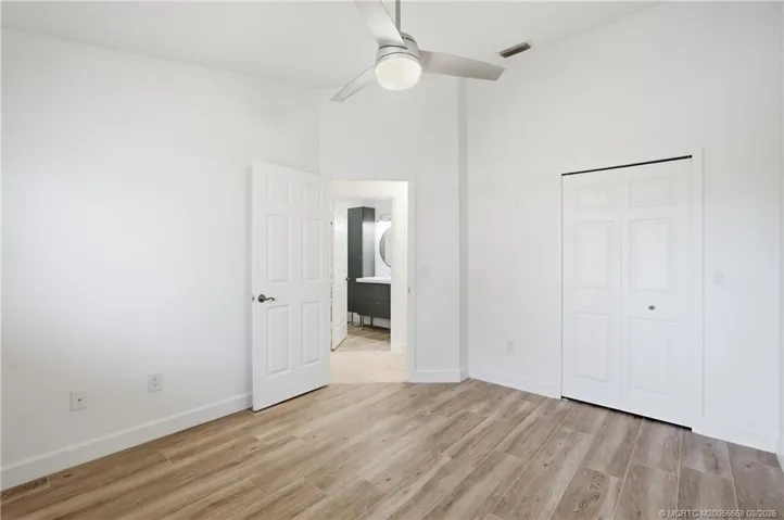 2nd Bedroom: large space with luxury vinyl plank flooring and views of green space.