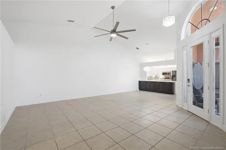 Open floor plan, large living area with high ceilings.