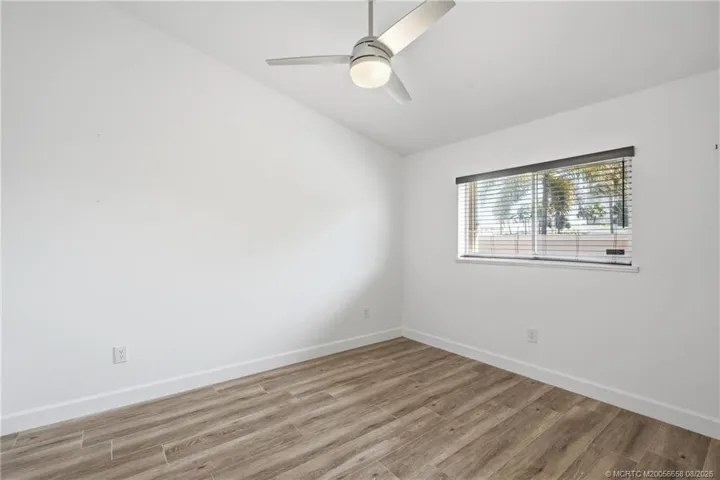 2nd Bedroom: large space with luxury vinyl plank flooring and views of green space.