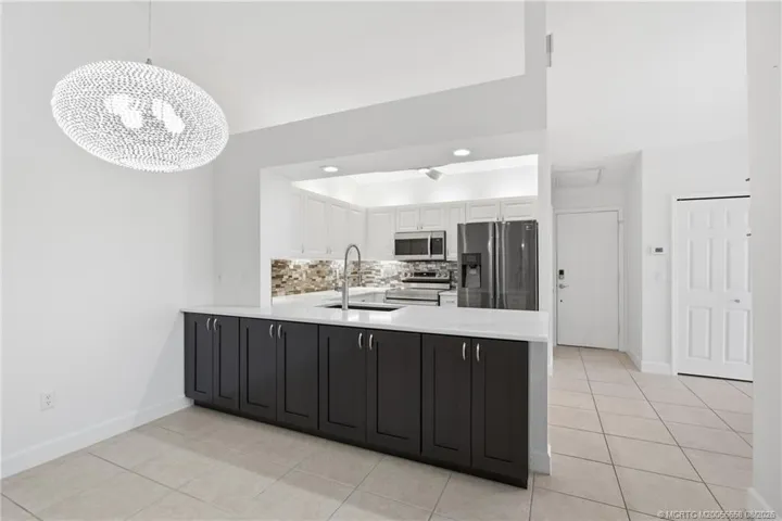 Virtually staged living space. Open floor plan, large living area with high ceilings.