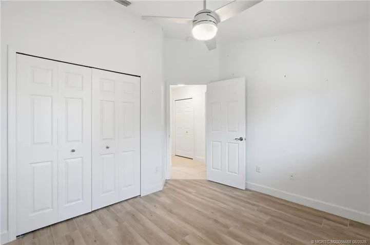 3rd Bedroom: large space with luxury vinyl plank flooring and views of green space.