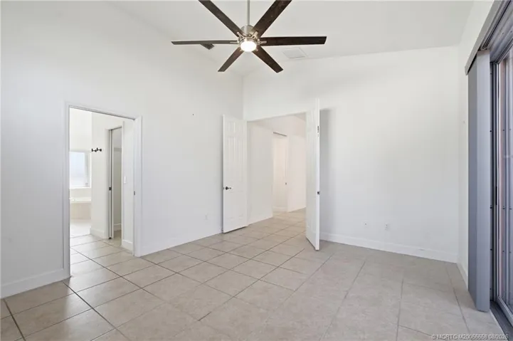 Large primary suite with lots of light and views of the patio.