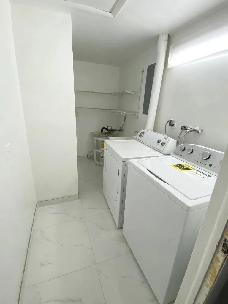 Laundry room has a sink also. located by the foyer.