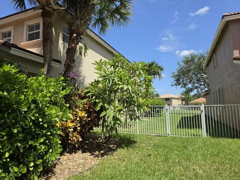 Lush side view of home.