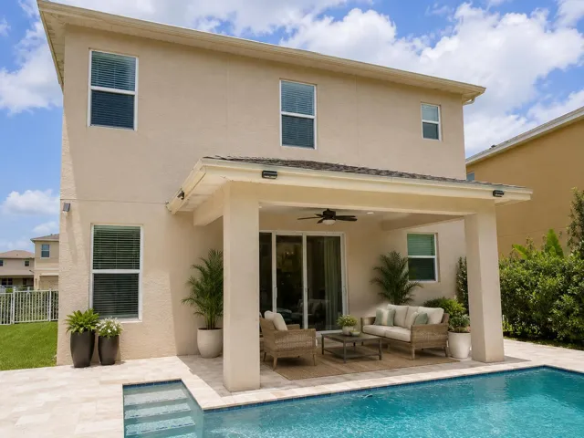 Back yard oasis with heated pool, truss covered patio, and artificial turf/grass. NO GRASS TO MAINTAIN!