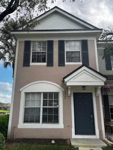 Two-story exterior with a gabled roofline and stucco finish