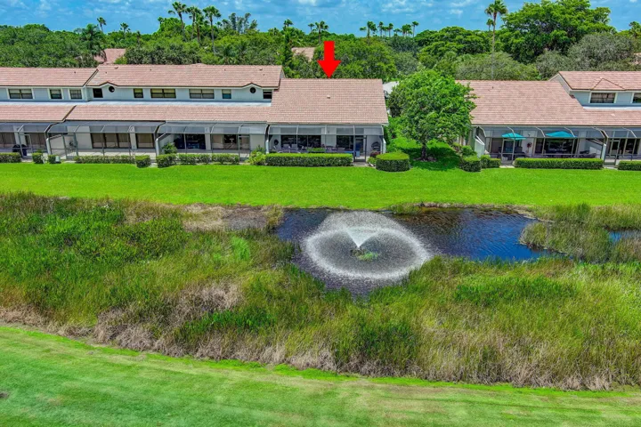 Lush green lawn with a pond featuring a decorative fountain