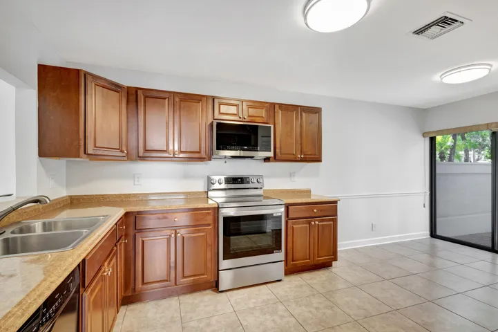 Bright and spacious kitchen with plenty of room for a breakfast table, offering an inviting setting for morning coffee and casual everyday dining.