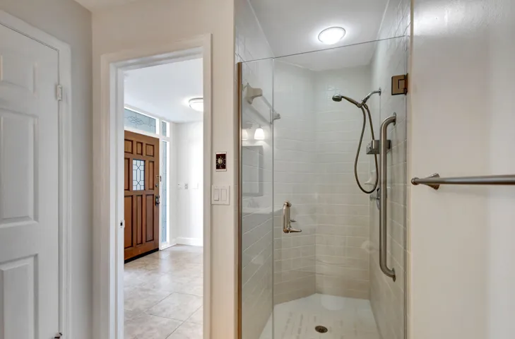 Fresh and comfortable guest bathroom featuring a walk-in shower with a sleek frameless glass door.