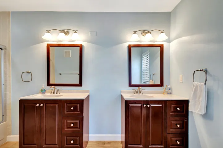 Spacious primary bathroom featuring two separate vanities, providing individual space and added convenience.