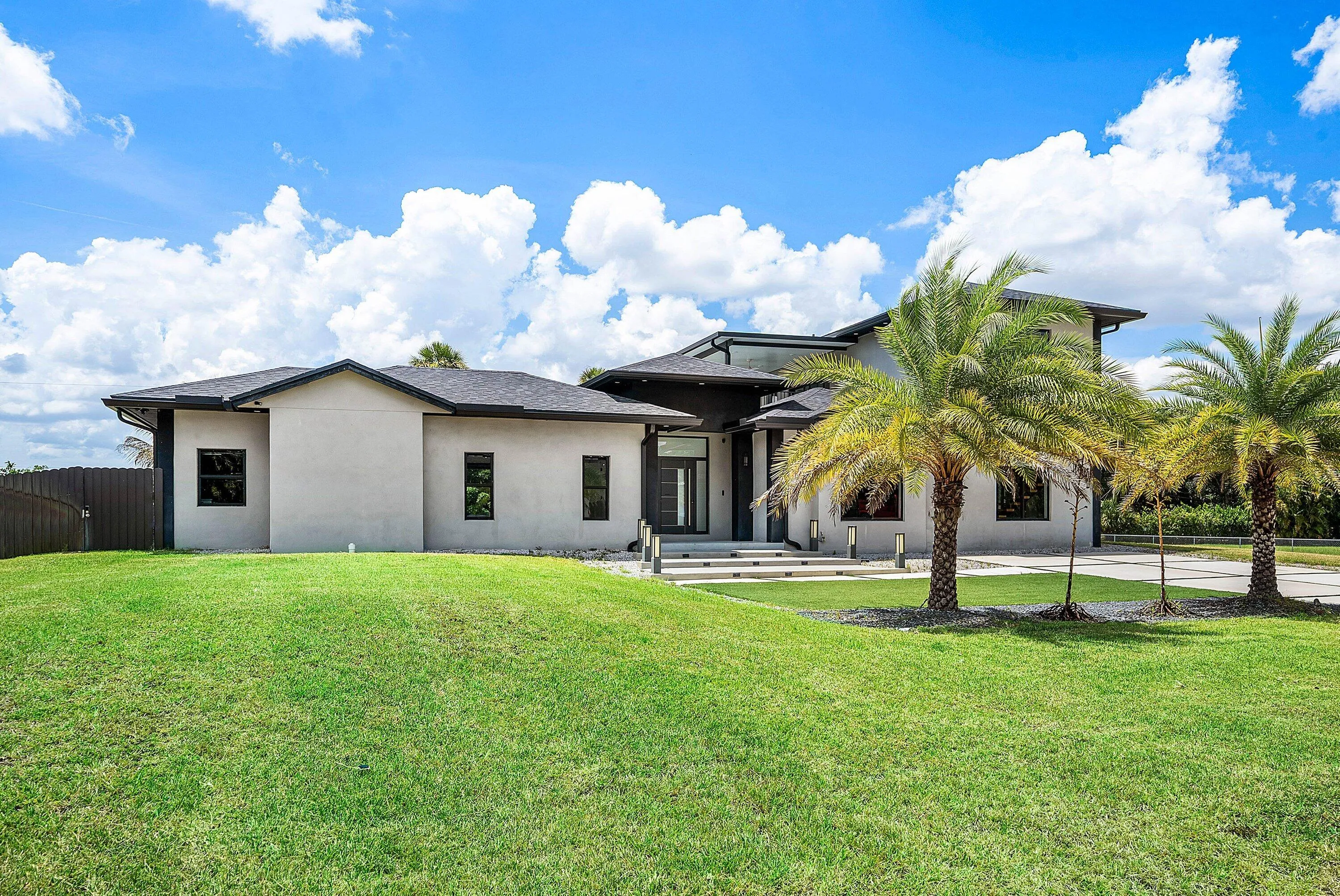 Modern stucco exterior with a dark trim roofline