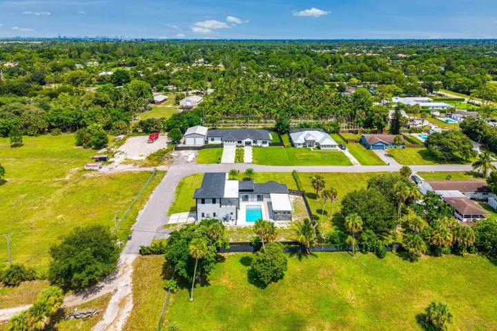 Aerial perspective showcasing a modern residence with a private swimming pool