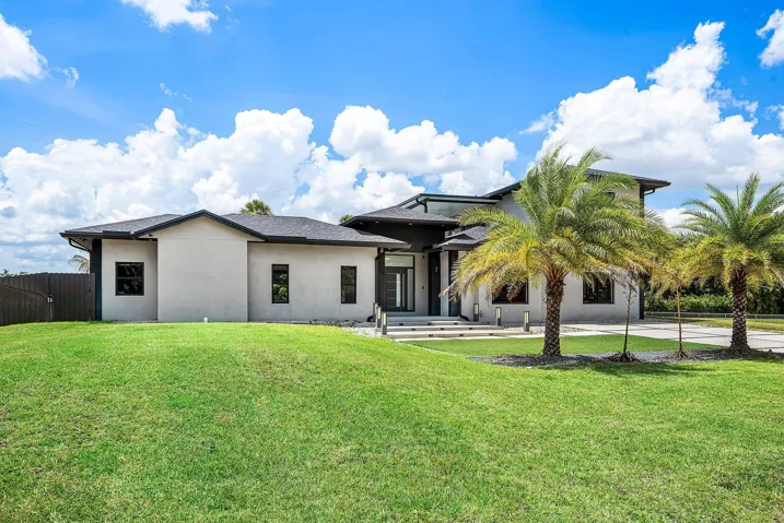 Modern stucco exterior with a dark trim roofline