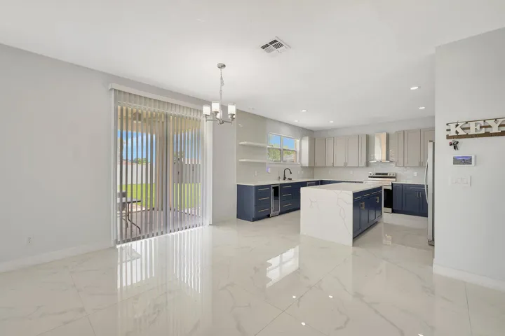 Spacious kitchen with a large island, two-tone cabinetry, and stainless steel appliances