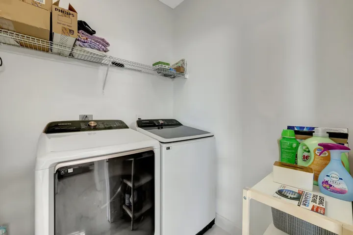 Laundry area featuring wire shelving and white walls