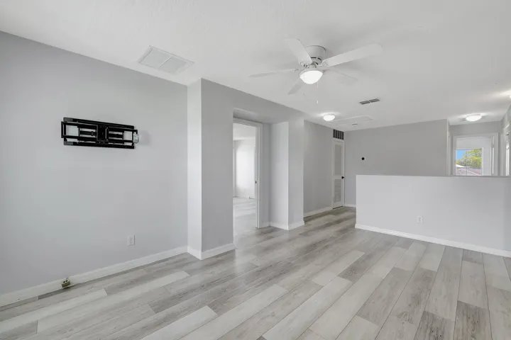 Wood-finish flooring throughout, with neutral wall paint and white trim