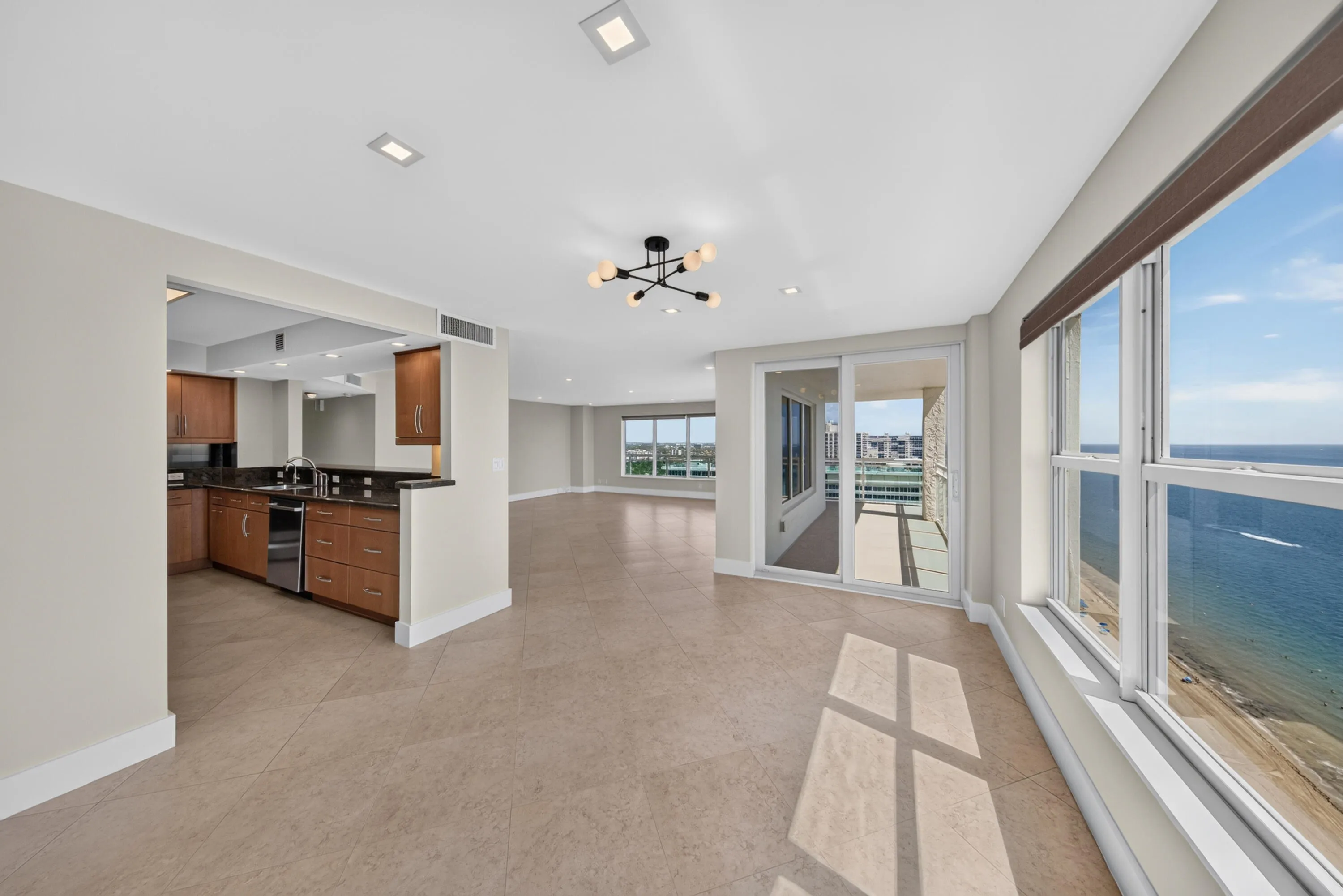 Ocean and Intracoastal coastline views surround this bright corner residence with access to the wraparound balcony.