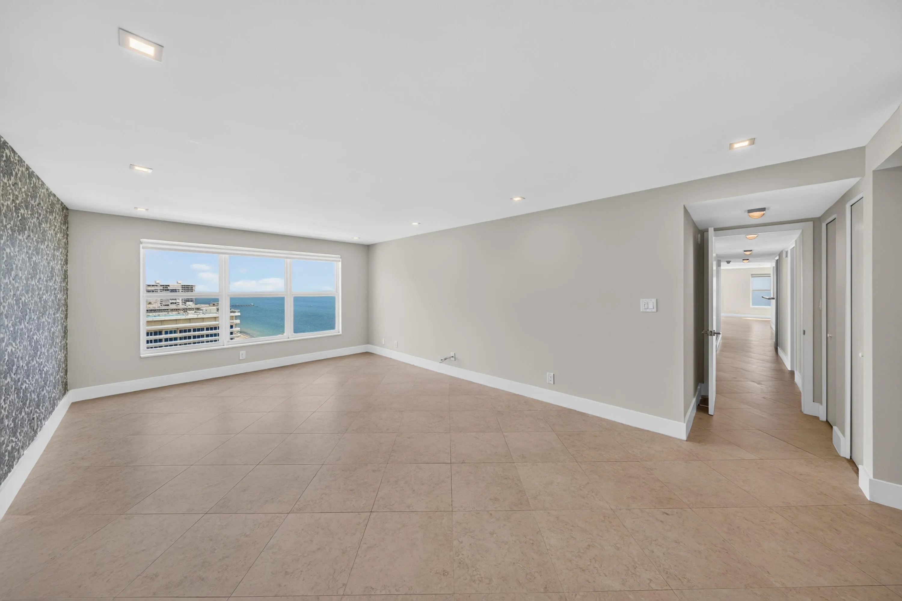 The generously sized primary bedroom offers excellent wall space, abundant natural light and ocean views.