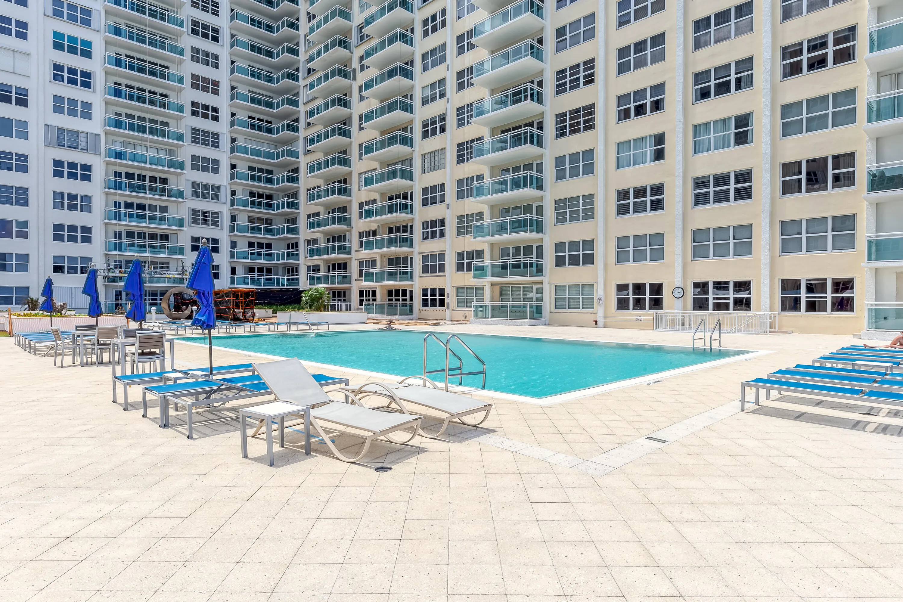 Spacious pool terrace offering abundant areas for relaxing, socializing and enjoying the South Florida sunshine.