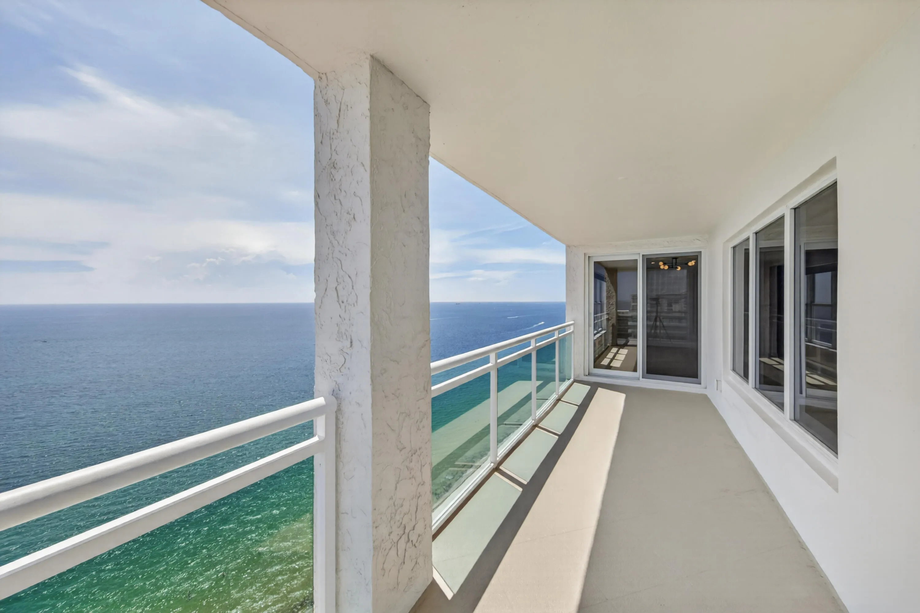 The generous covered balcony provides exceptional outdoor living with endless ocean views.