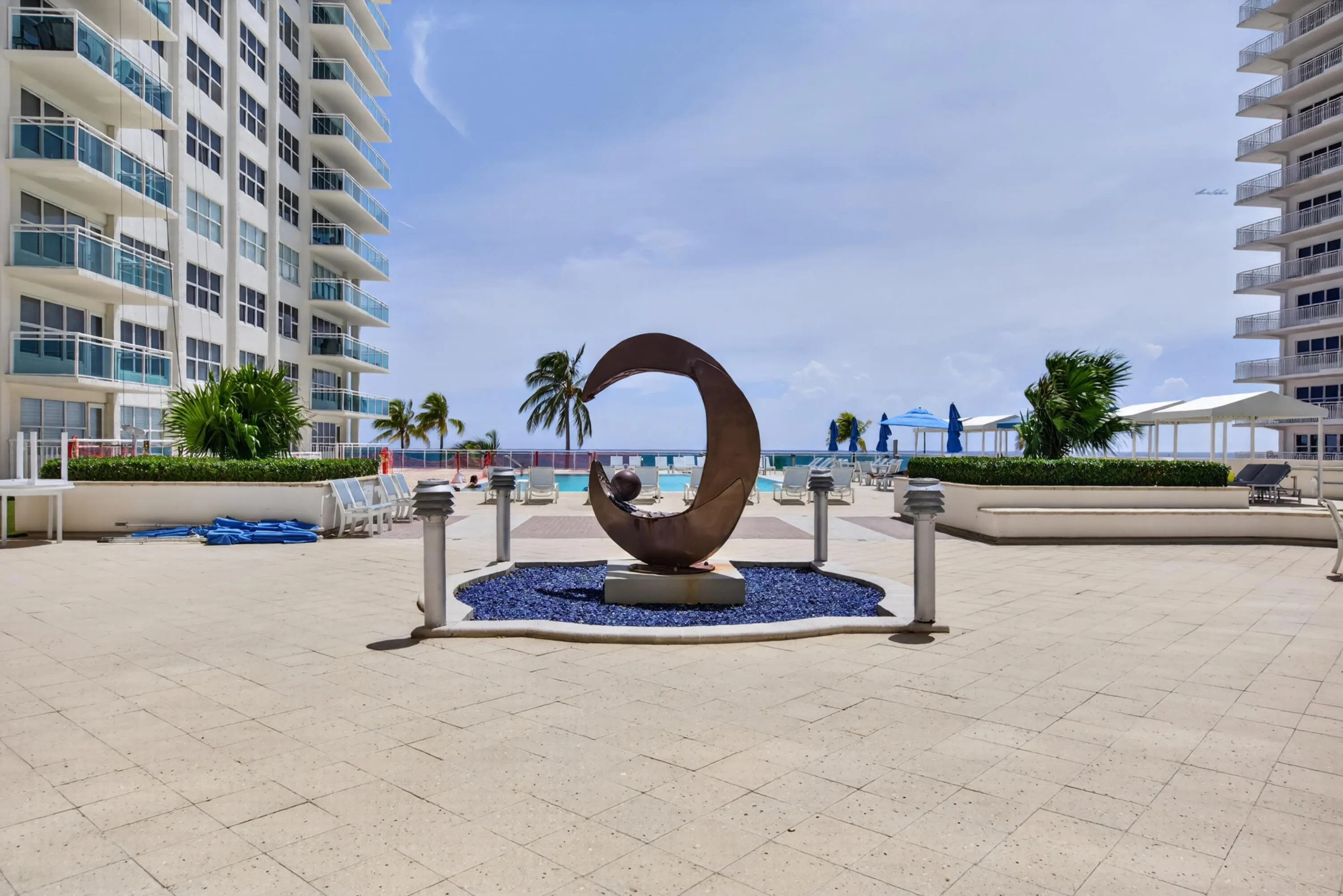 A generous outdoor terrace connects the resort-style amenities with the building’s direct beachfront setting.