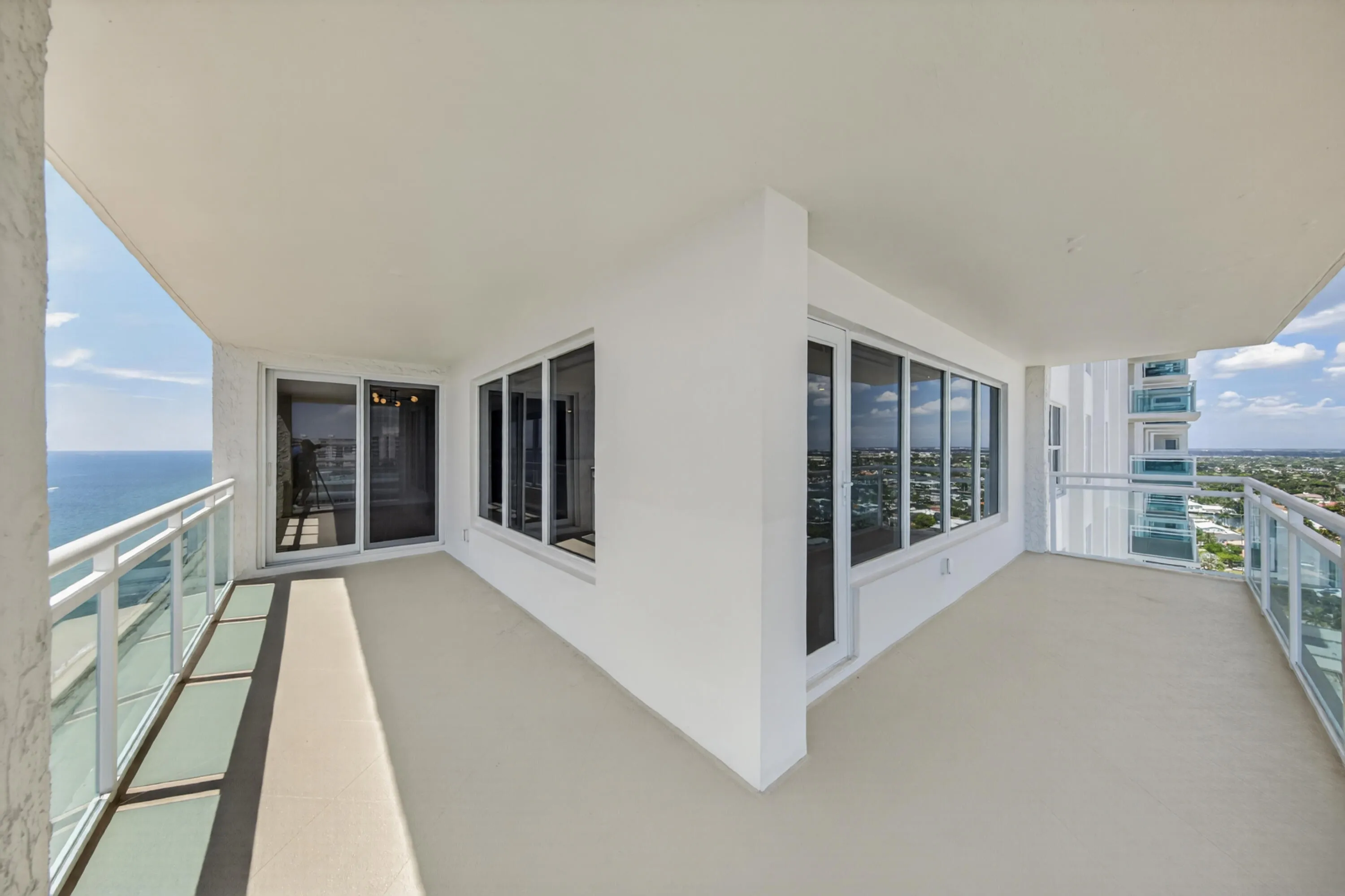 The wraparound design captures both Atlantic Ocean and western skyline views from this northeast corner residence.