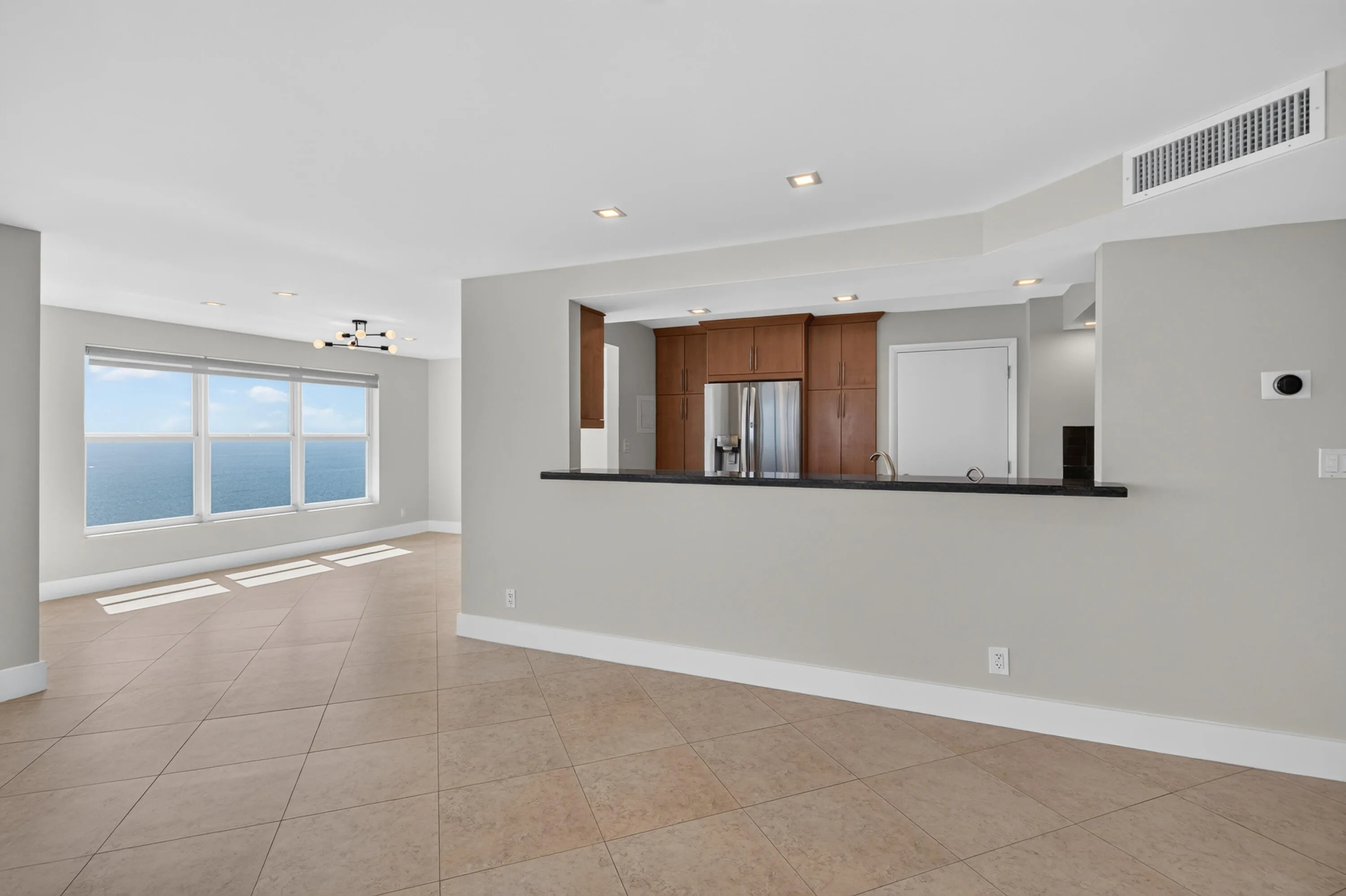 The open kitchen connects effortlessly with the dining and living spaces for relaxed coastal entertaining.