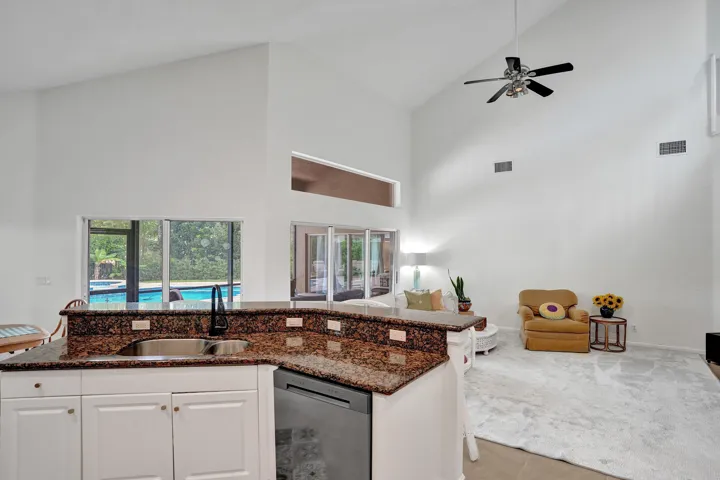 Kitchen peninsula with stone countertops and an undermount sink