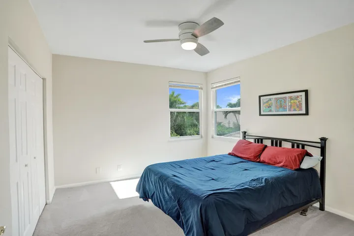 Neutral wall tones with light plush gray carpeting, impact windows