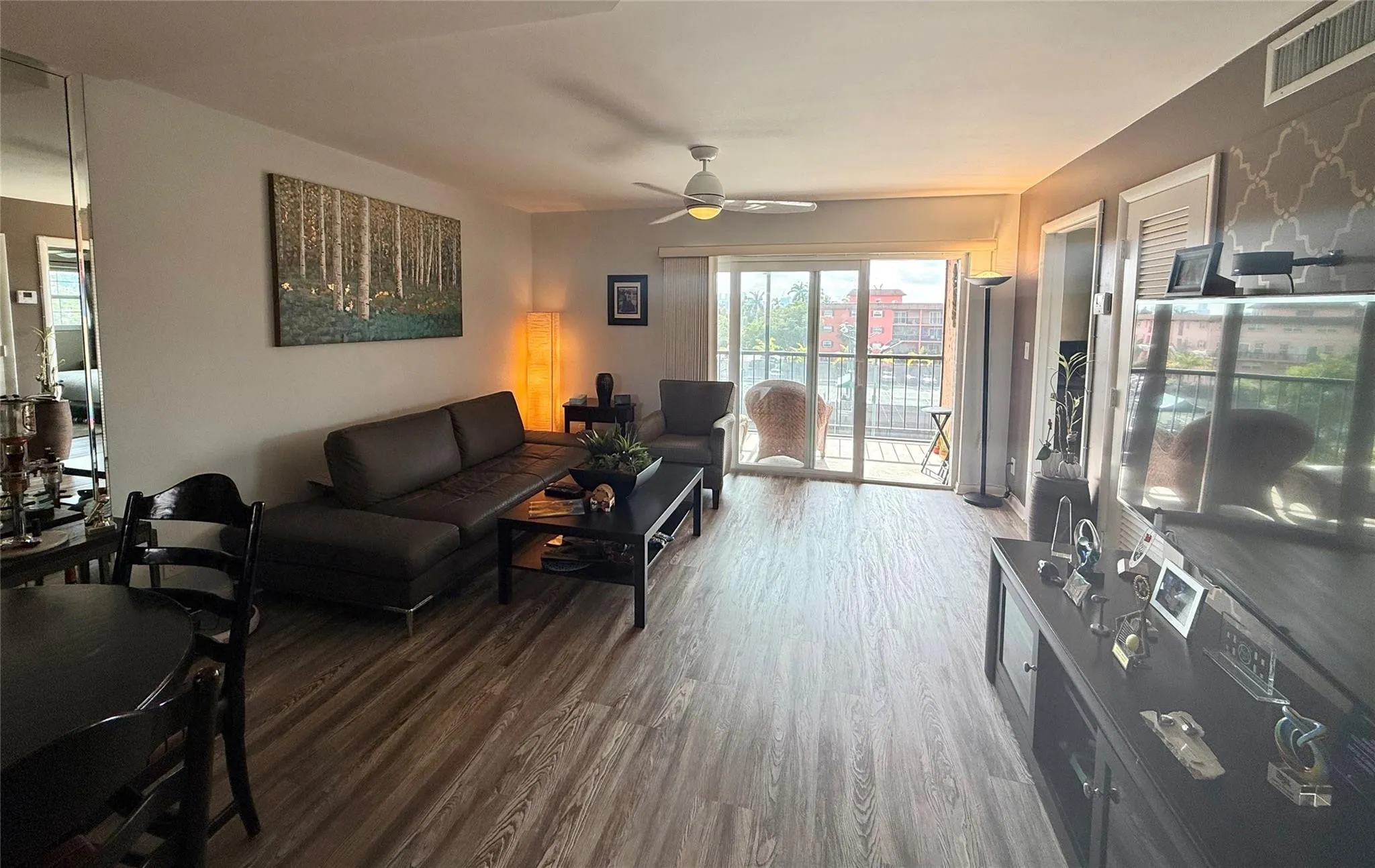 Laminate wood flooring, impact sliders out to balcony overlooking tennis courts