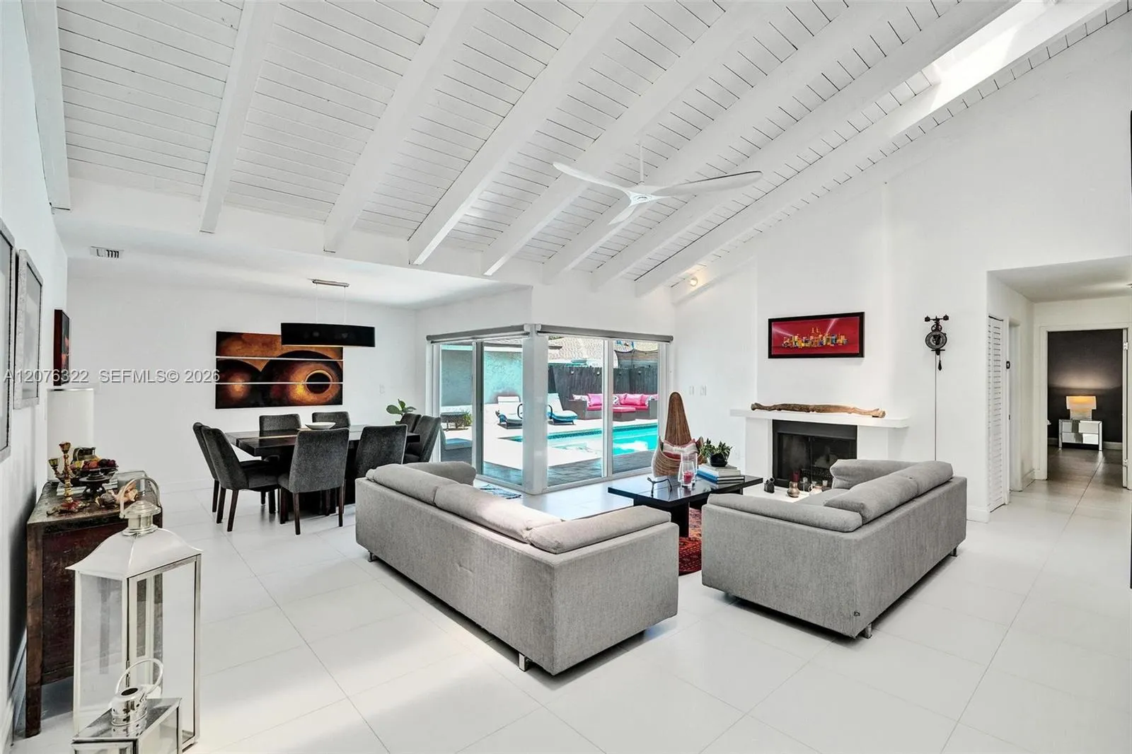 Wow! Vaulted Ceilings, fireplace, gorgeous flooring, view to pool deck, skylights. IMPACT WINDOWS.