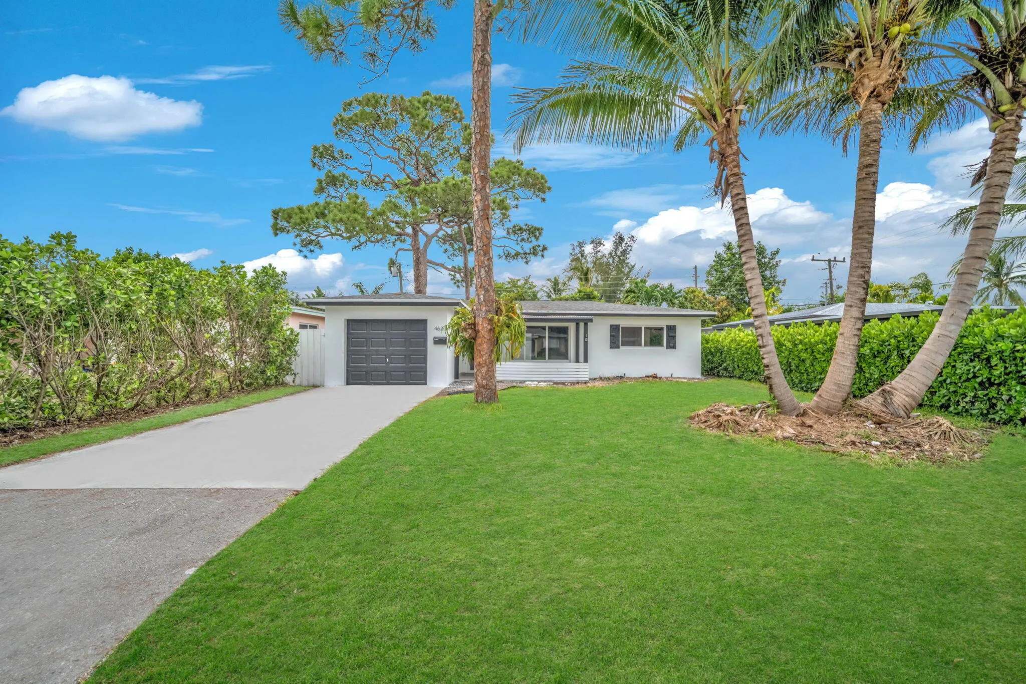 White exterior with black garage door and shutters