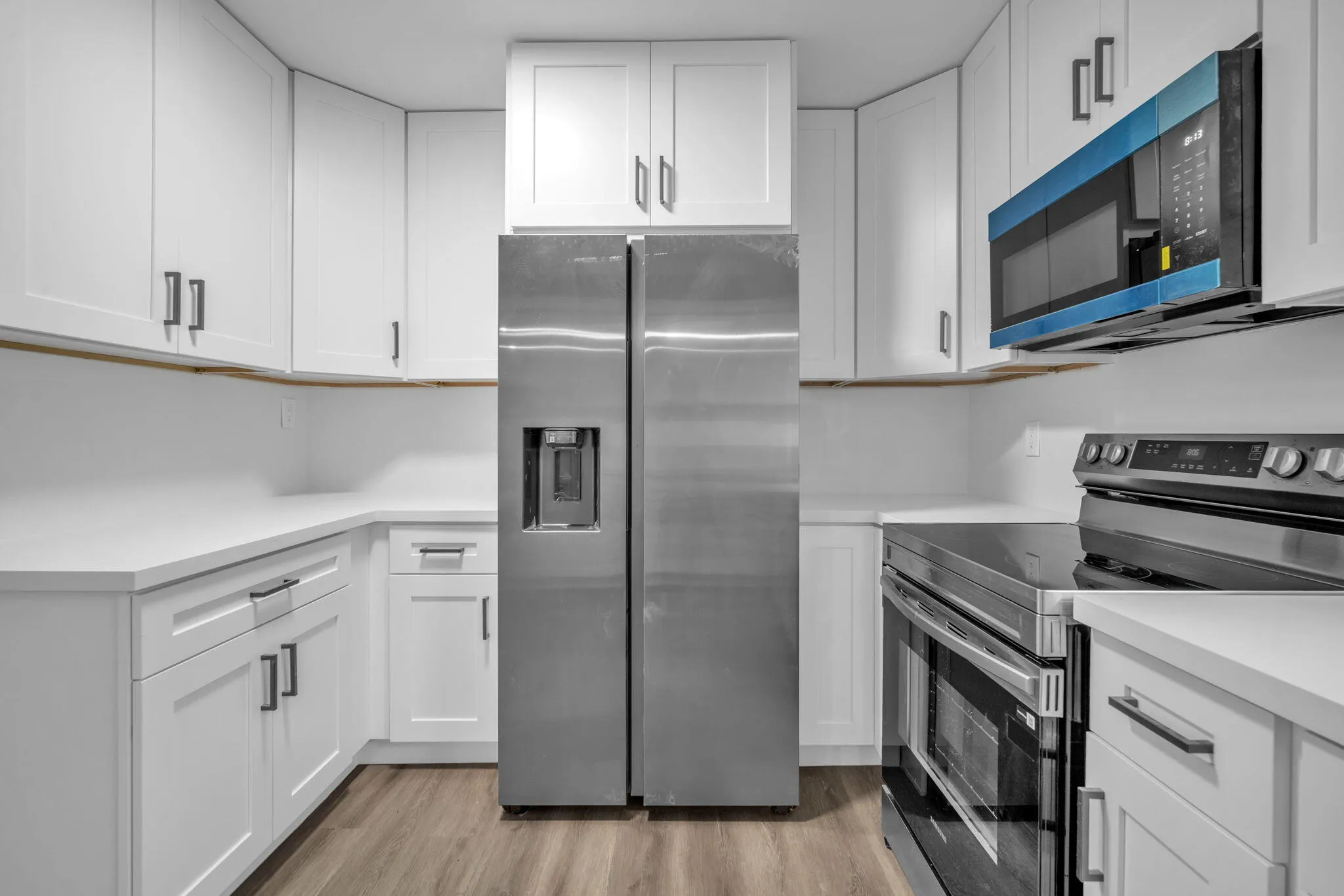 White shaker-style cabinetry with dark hardware