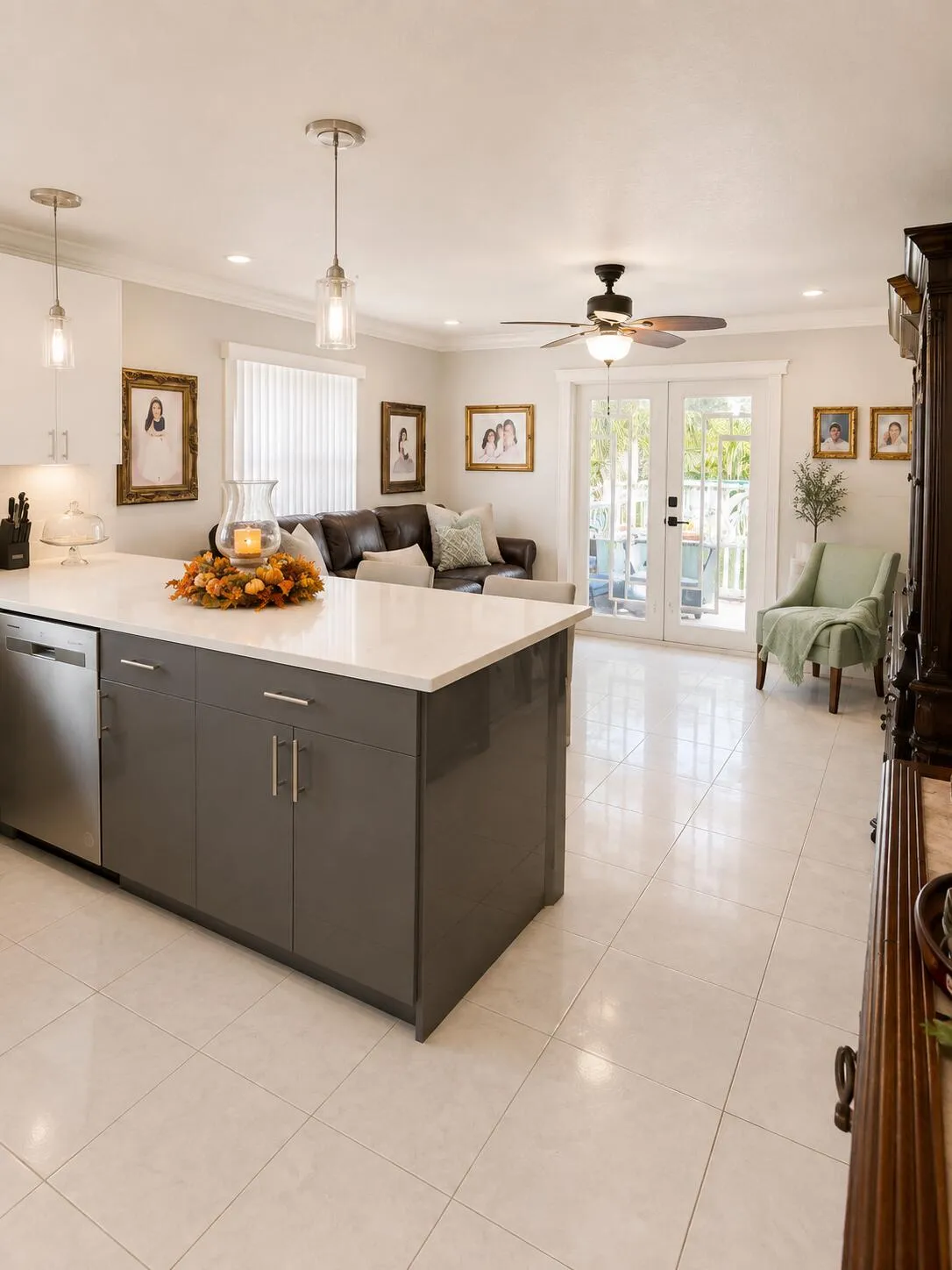 Central kitchen island with gray cabinetry, white countertop, and stainless steel dishwasher