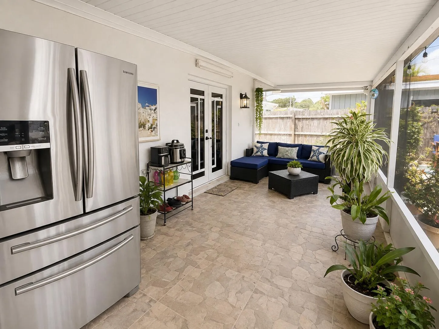 Screened patio with tile flooring, white plank ceiling, and dual French doors