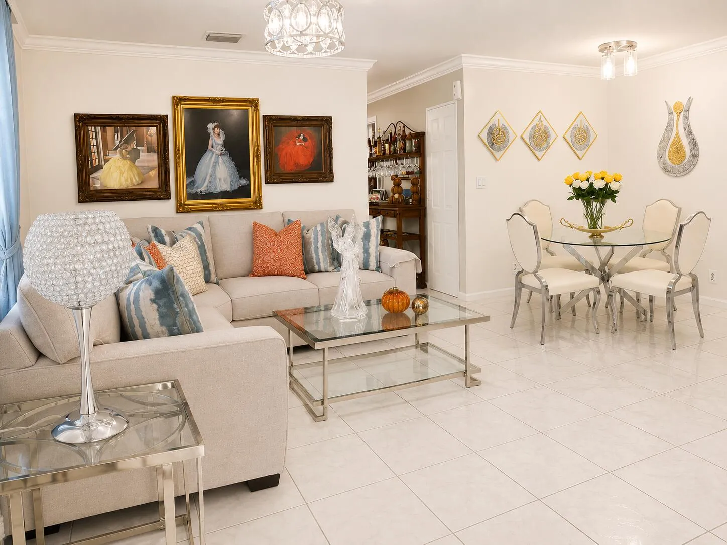 White tile flooring throughout, crown molding, and a modern chandelier