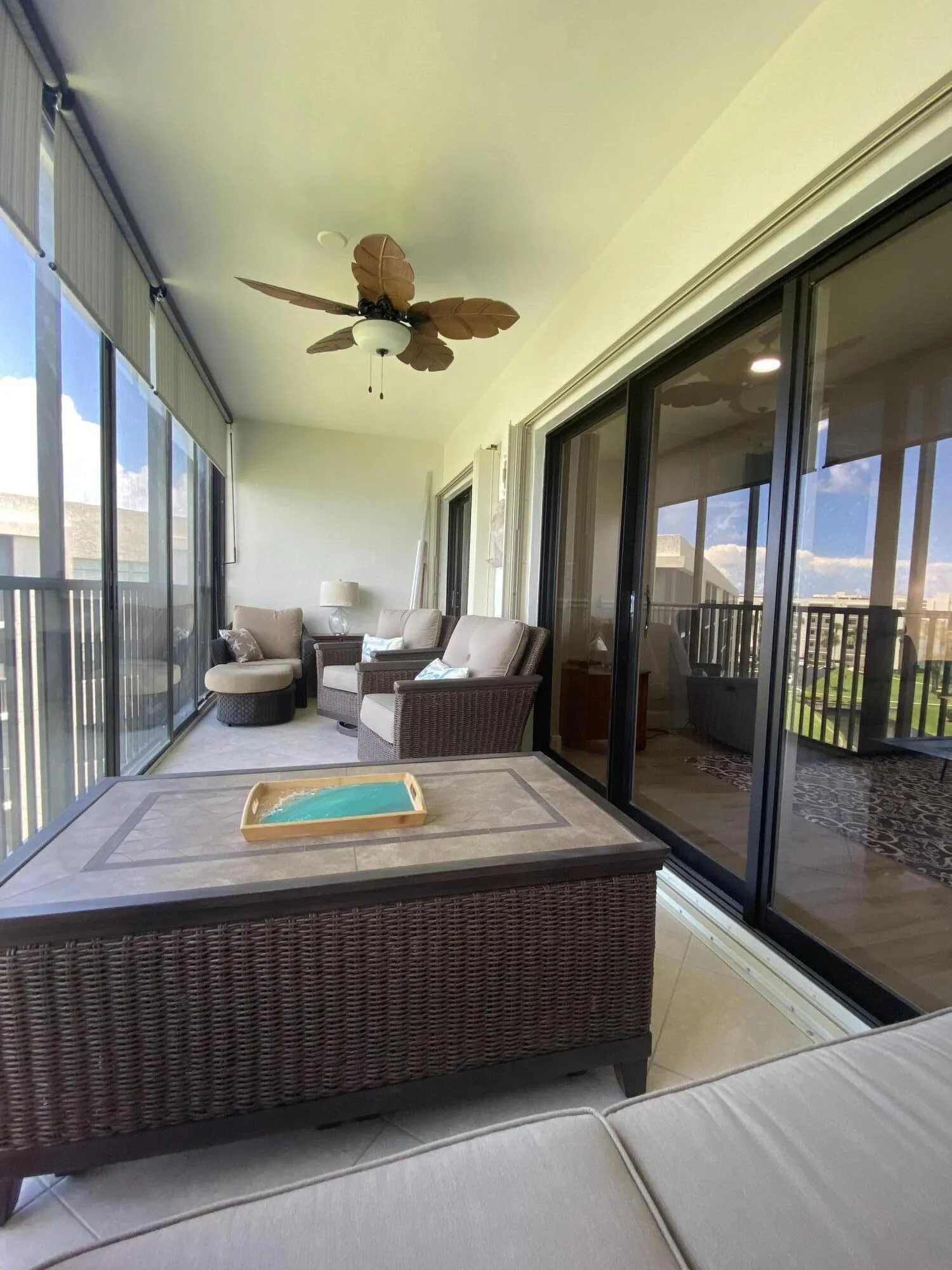 Screened patio with tile flooring and a ceiling fan