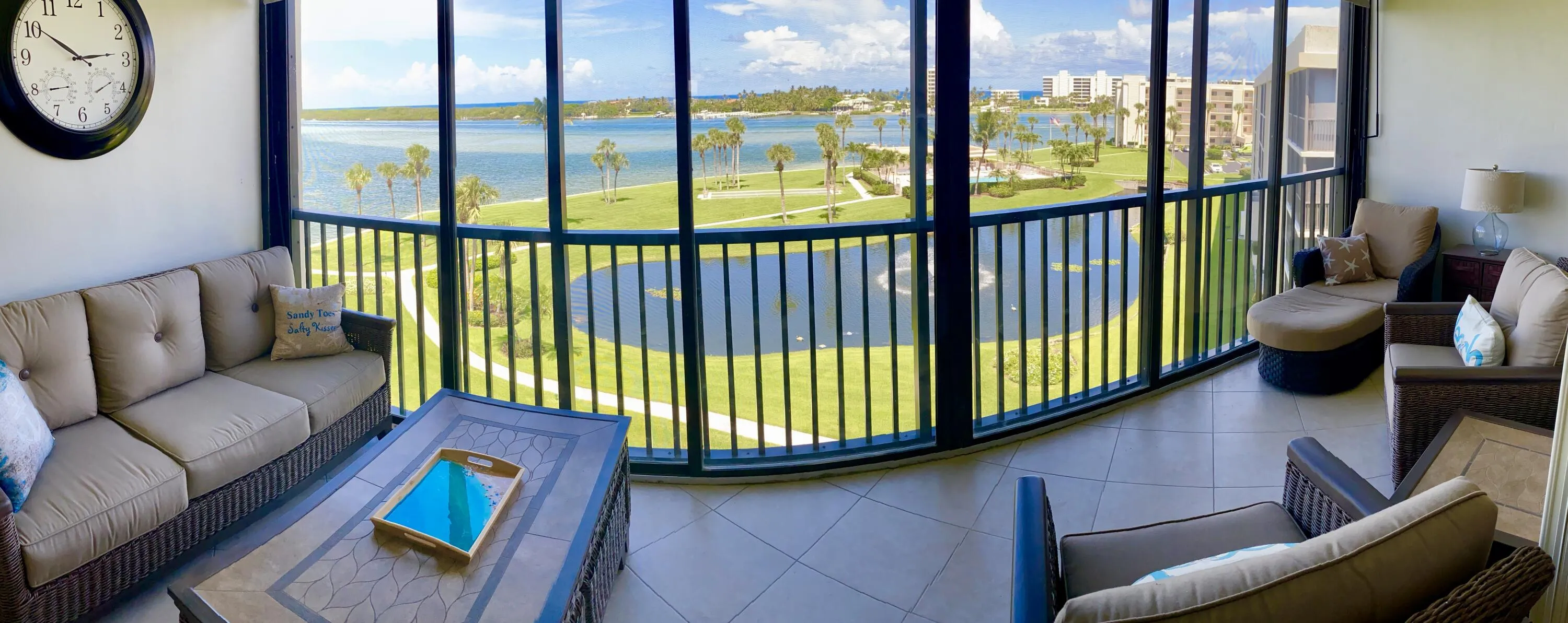 Screened balcony featuring tiled flooring and expansive water and landscape scenery