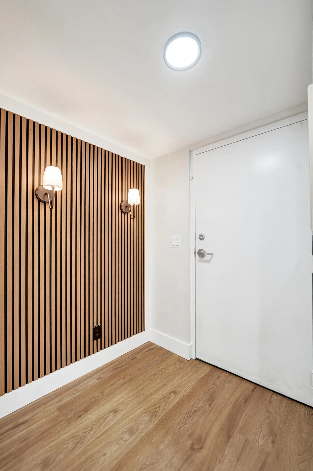 Foyer - Sconces and real wood offer a warm welcome