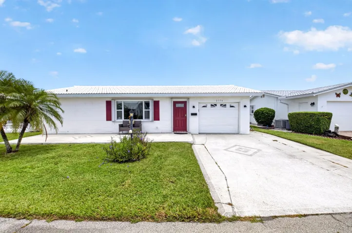 White exterior with red door and shutters