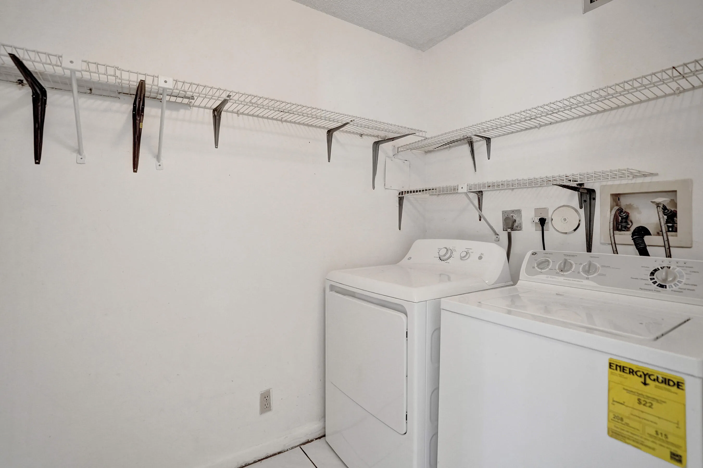 Laundry room + Storage area. White wire shelving system