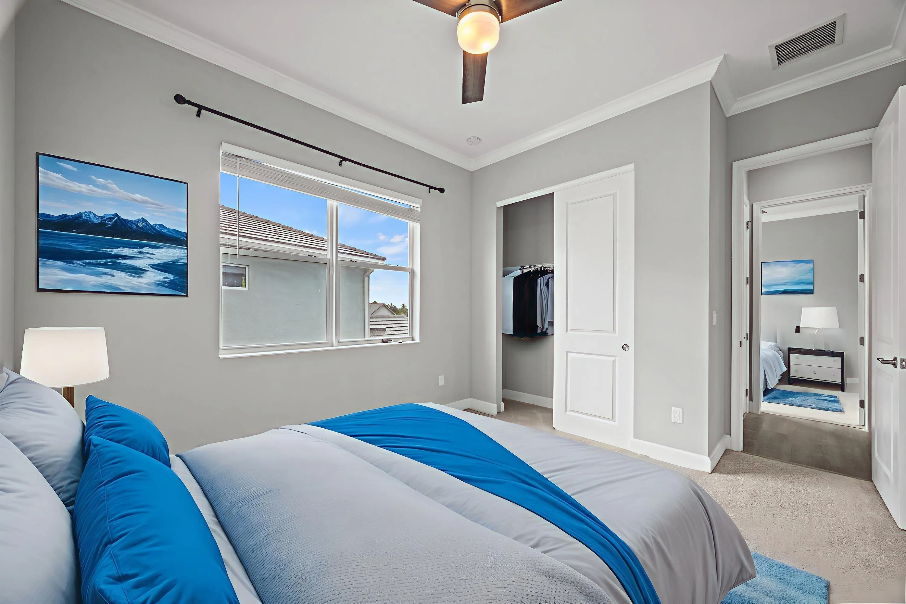 Recessed window with blinds, ceiling fan with integrated lighting, built-in closet with sliding panel doors, and neutral wall paint