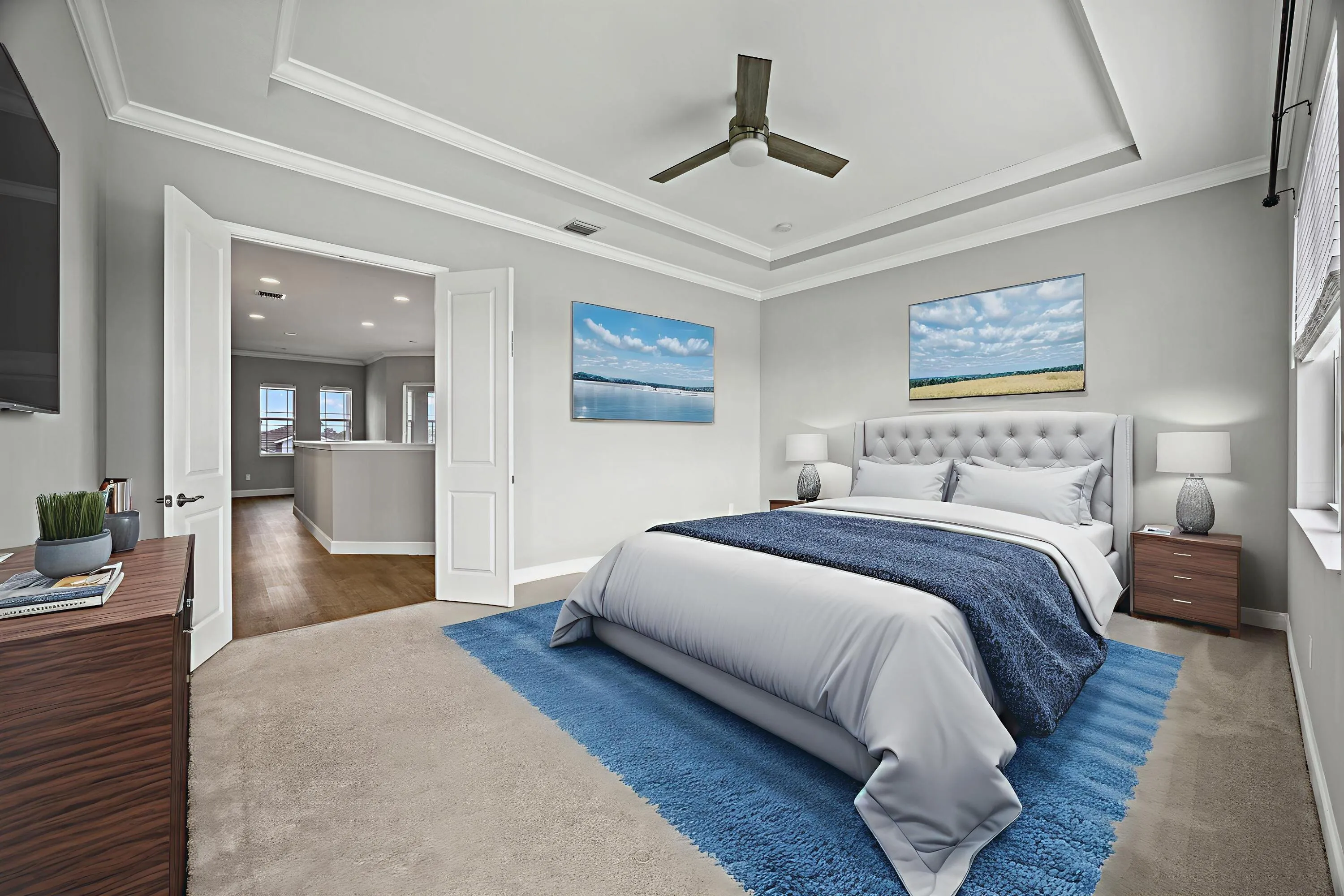 Tray ceiling with crown molding, plush carpet, recessed lighting, ceiling fan, and double doors